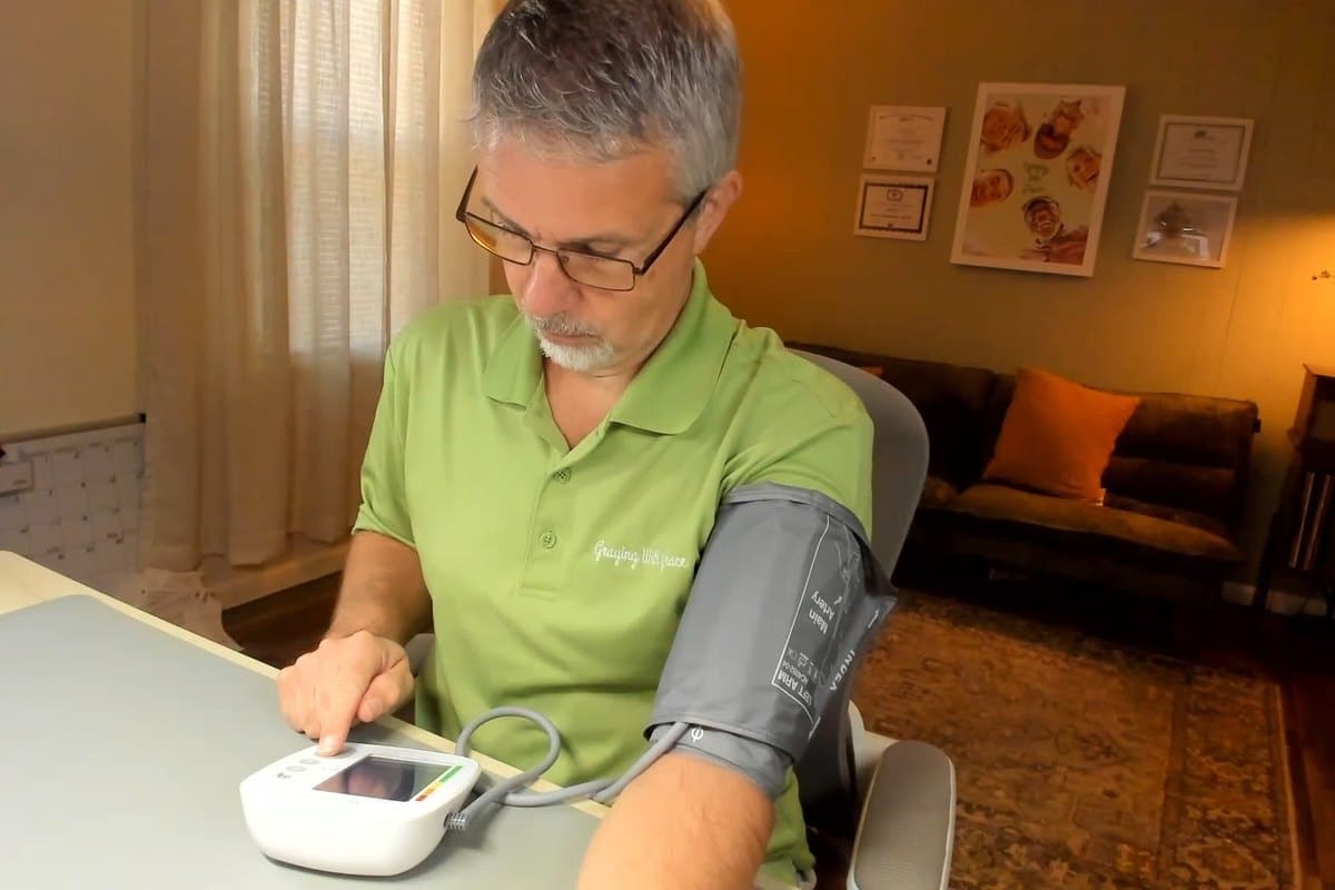 Scott wearing the FondCircle A3 cuff and pressing start on the monitor at his desk